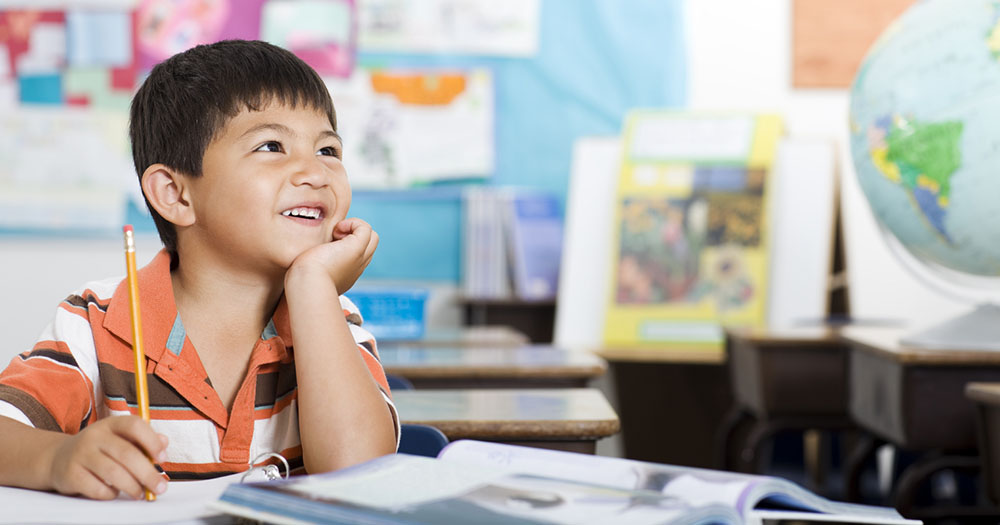 Image of child smiling while learning